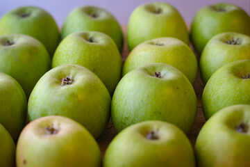Apples stand on a wooden surface