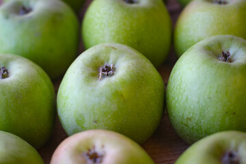 Apples stand on a wooden surface