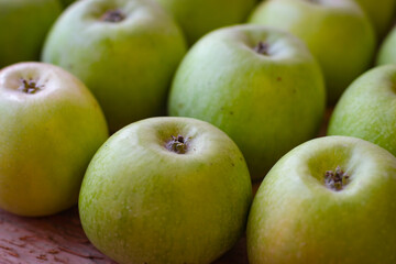 Apples stand on a wooden surface