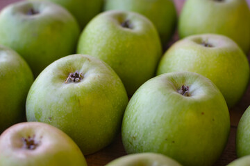 Apples stand on a wooden surface