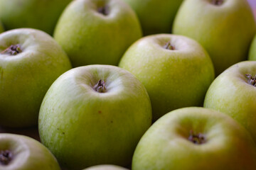 Apples stand on a wooden surface