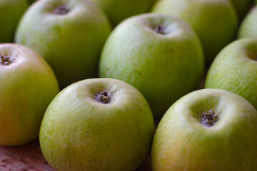 Apples stand on a wooden surface