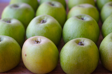 Apples stand on a wooden surface