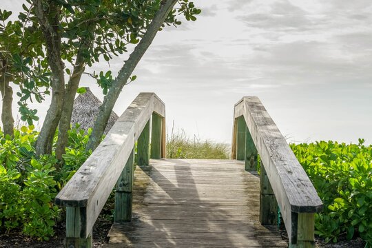 Wooden bridge to a sandy beach on Sanibel Island in Florida