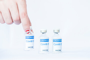 Close up of woman hand pick up one of COVID-19 coronavirus vaccine form many vial for immunization on isolated background.  Breakthrough in the innovation and against coronavirus  2019 or COVID-19