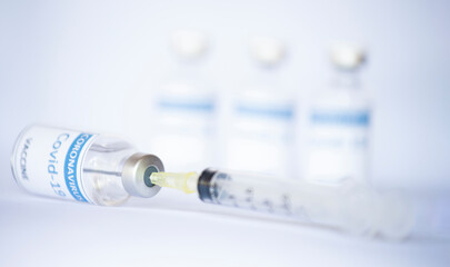 Vaccine covid19 in vials with syringe isolated white background, Mers-Cov ,Concept vaccine in vials for stop. Flu coronavirus pathogen that attacks the respiratory tract. Pandemic virus infection