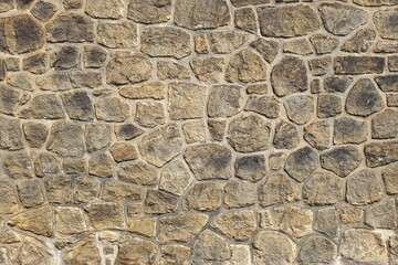 Stone wall with tightly fitted stones and abstract mosaic back ground pattern