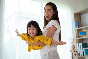 Child pilot dreams of traveling, mother and daughter play together.