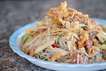 Papaya salad with crab and fermented fish mix with rice noodles, pork sausage and fermented pork