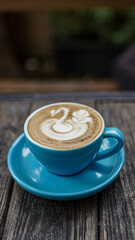 coffeelatte with blue cup and goose draw in topping