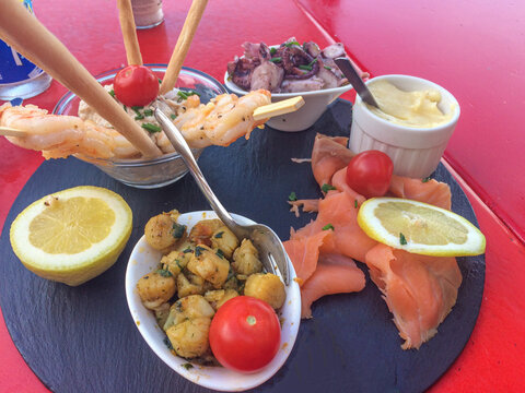 fresh seafood platter with smoked salmon, shrimps, octupus