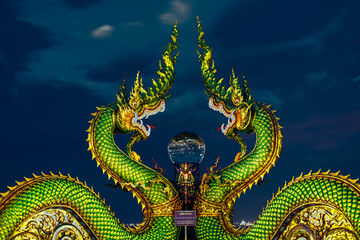 Background of Thailand's Chonburi religious attractions (Wat Khao Phra Khru viewpoint), with beautiful Buddha and Phaya Naga statues, tourists always come to make merit and take pictures at night.