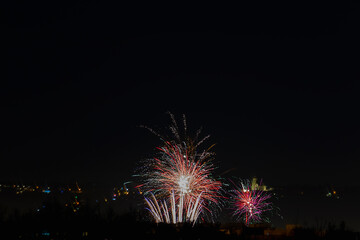 Fototapeta na wymiar Amazing colorful fireworks on dark sky above city Ceske Budejovice, Czech republic. New years eve celebration