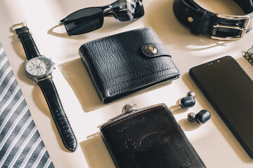 Top view male object, watch, flask, tie, belt, cell phone, wallet, notebook, headphones. Modern male accessories.