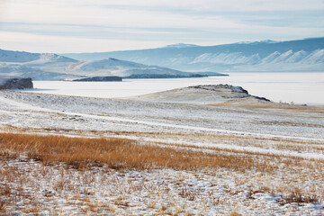 Grass and snow on Olkhon Island. Winter landscape