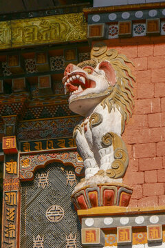 Colorful traditional snow lion guardian carved in stucco and painted in Punakha dzong, Bhutan