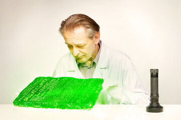 Museologist examining artifact of emerald tablet on his workplace