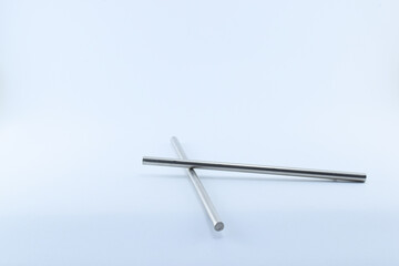 photo of stainless poles isolated on white background crossed each other