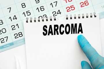 The doctor points to the text SARCOMA, medical concept