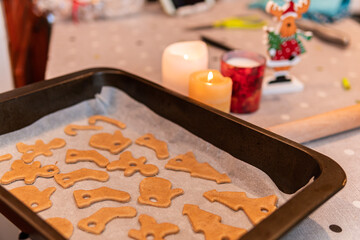 A process of cooking Christmas gingerbread biscuits of a different shape in oven