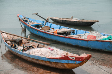 Fototapeta na wymiar Traditional Vietnamese fishing boats carrying nets and moored at Duy Vinh Fishing Village in Vietnam