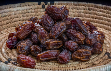 Dried dates with tea in a basket 
