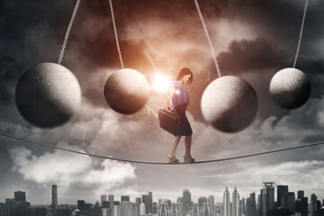 Businesswoman walking on a rope with obstacles - obrazy, fototapety, plakaty