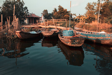 Wooden boats moored on the riverside at Ben tre, Mekong Delta Vietnam