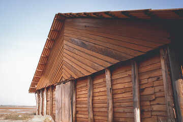 Cinematic scenery of a traditional wooden salt storage house in the salt fields or farm in Kampot, Cambodia