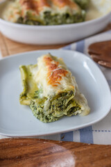 Cannelloni with ricotta and wild garlic spinach. Italian cuisine