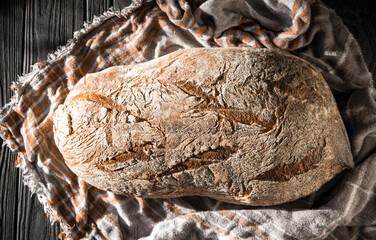 High angle shot of black bread on a wooden background