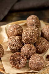 Chocolate coconuts. Chocolate balls with coconut. Chocolate candies or cookies with coconut, cinnamon and powdered sugar	