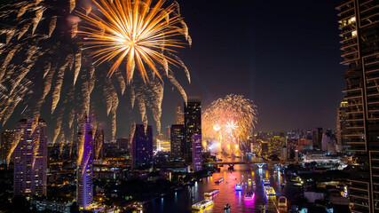 Holiday in cityscape of  Bangkok thailand with Multicolored bright festive fireworks in the night sky