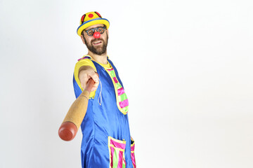 The clown is a man in a bright blue and yellow suit with a baseball bat.