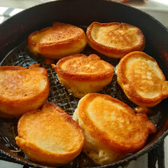 Tiny pancake cereal quarantined trending food. mini pancakes are fried in a pan in the kitchen. Cooking process. Live photo frying