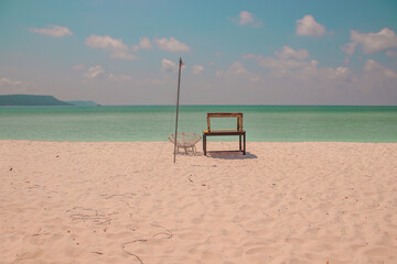 Scenic view of a lone beach chair against the blue sea and summer sky in Koh Rong Island in Cambodia