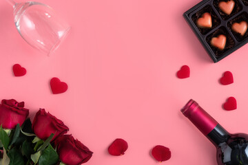 Valentine's Day dating gift with wine and rose concept on pink background