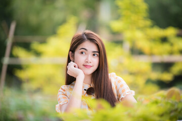 Fototapeta premium Portrait beautiful asian woman lifestyle resting in the park, relaxation concept, mind care