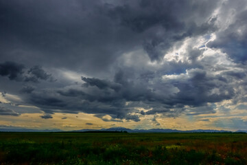 Fototapeta na wymiar dark rain clouds before rain in a flat landscape