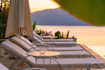 Beautiful tropical sunset scenery, sun beds, loungers, umbrella 