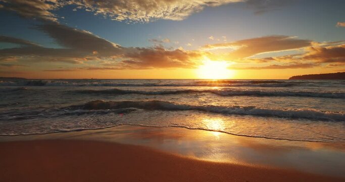 Ocean beach sunrise with dramatic cloudscape, 4K video
