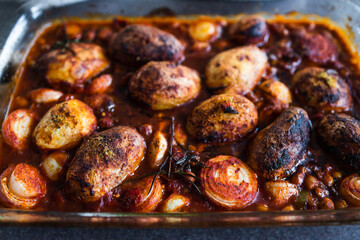 plant-based food, vegan potato and onion roast with chickpeas tomato sauce and herbs
