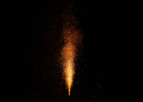 Firecracker sprays a fountain into the night, concept of new year's eve and celebrations