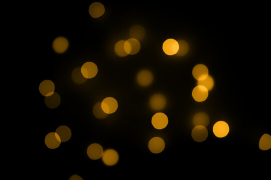 Yellow round bokeh on black isolated background
