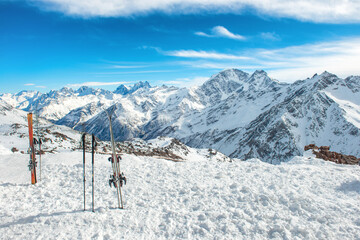 Fototapeta na wymiar Ski in snow with snow blue winter mountains in clouds. Winter ski resort