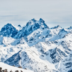 Fototapeta na wymiar Snow blue mountains in clouds. Winter ski resort