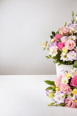 mock up two bouquets of different sizes of roses, daisies, lisianthus, chrysanthemums, unopened buds in a white paper box on a white background.