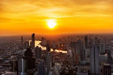 Fototapeta premium Golden Sunset Bangkok city of cityscape skyline with skyscraper building background in Central business district Bangkok, Thailand