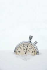 Fallen in the snow, in winter, stopwatch on a white background.