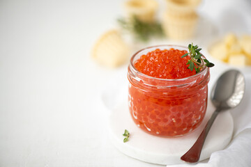 red salmon caviar in a glass jar